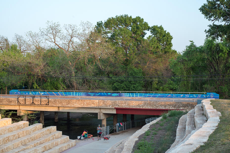 City of San Marcos dual nonverbal litter prevention mural commission over the San Marcos River, 2021