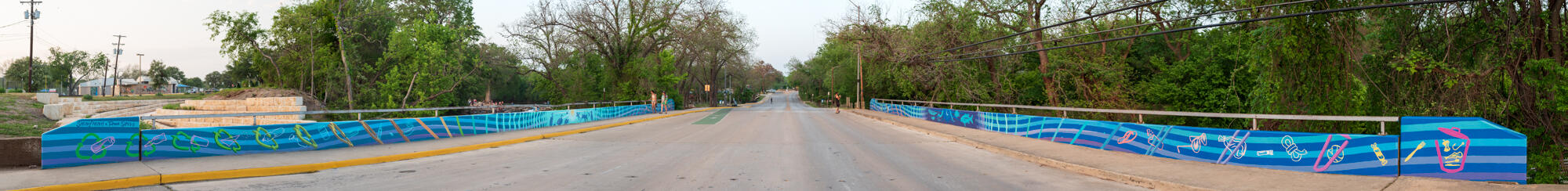 City of San Marcos dual nonverbal litter prevention mural commission over the San Marcos River, 2021